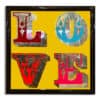 Vintage love sign with pure silver leaf on yellow background in gloss black frame