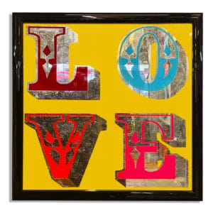 Vintage love sign with pure silver leaf on yellow background in gloss black frame